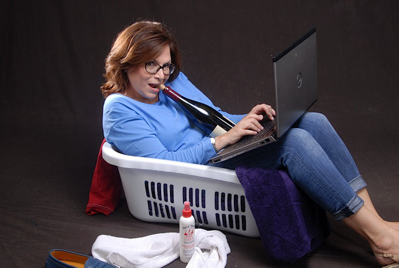 Risa In A Laundry Basket With Wine And Her Computer